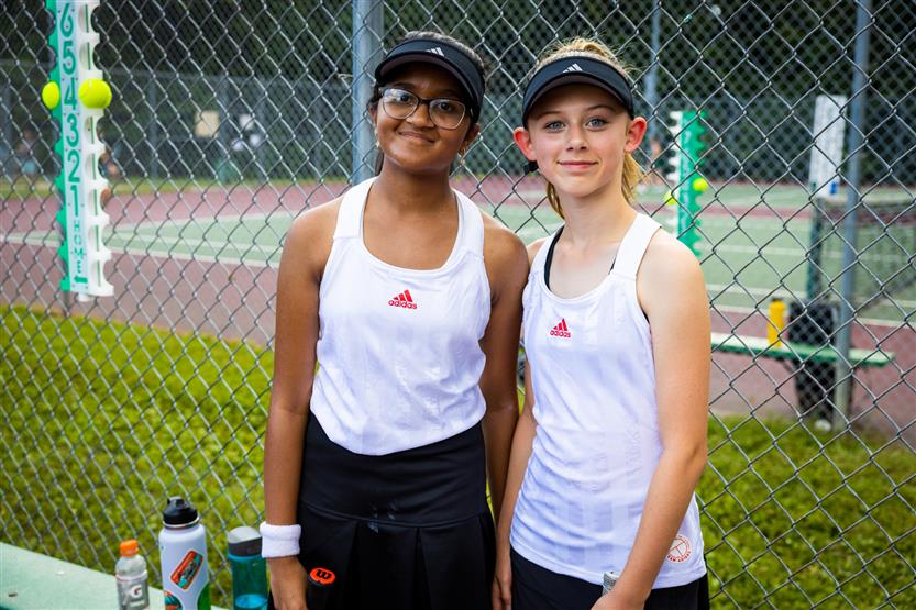 Two tennis players smile